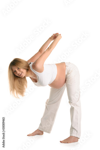 Pregnant woman standing and practicing yoga