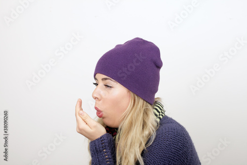 A young woman coughs