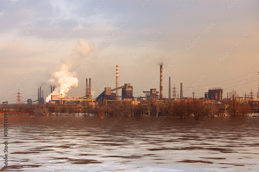 Panorama of metallurgical works reflected on water