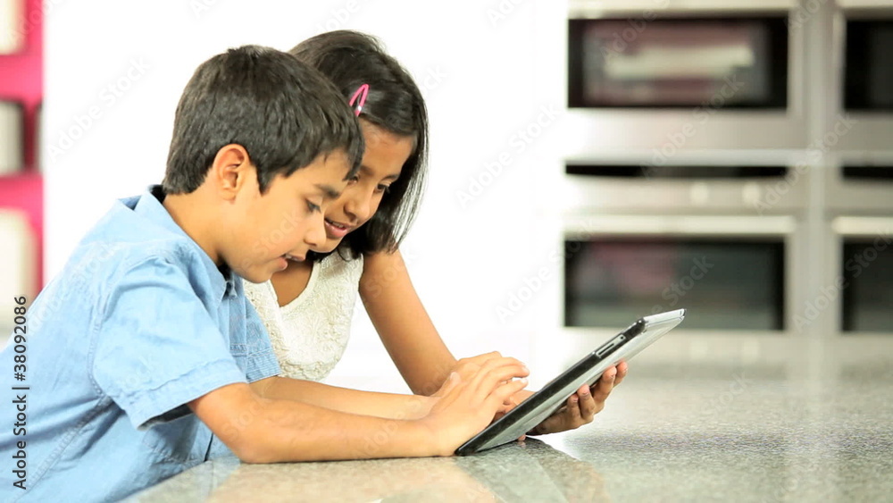 Asian Siblings Using Wireless Tablet Asian Siblings Using Wireless Tablet