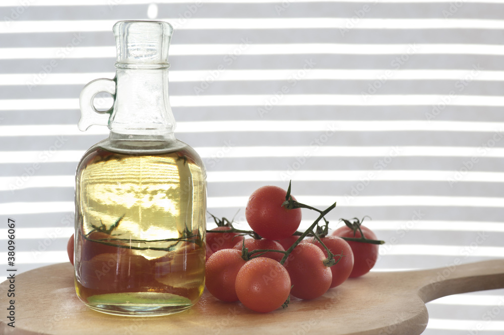 bottle of olive oil with tomato cherries bottle of olive oil with tomato cherries