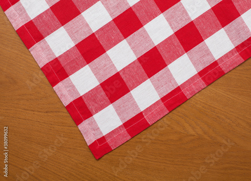 wooden kitchen table with red gingham tablecloth
