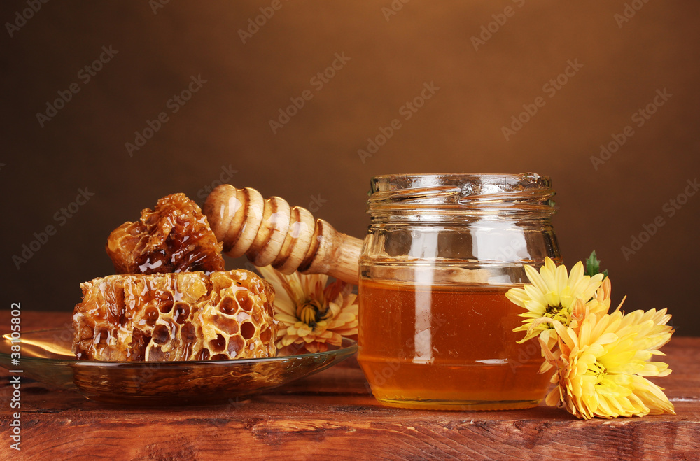 jar of honey,honeycombs and wooden drizzler jar of honey,honeycombs and wooden drizzler