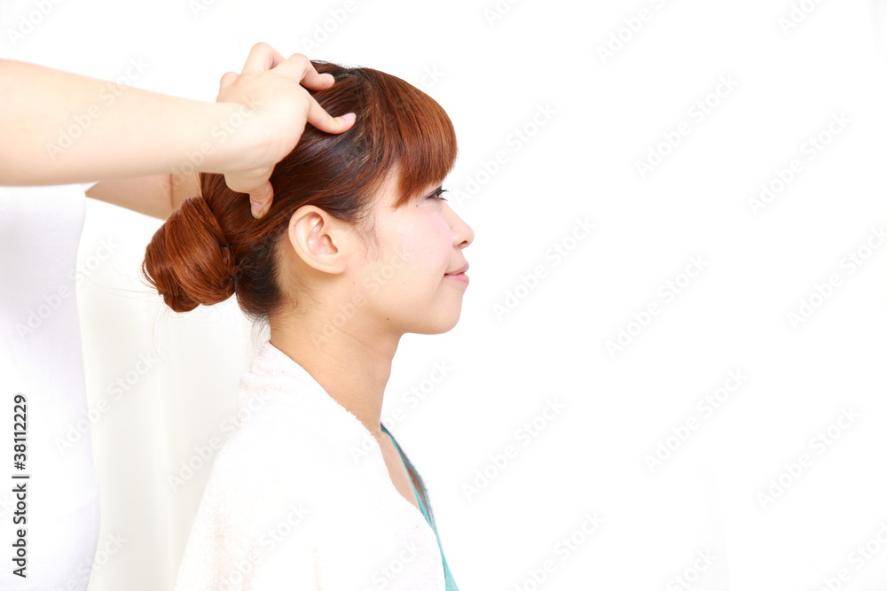 young Japanese woman getting head massage young Japanese woman getting head massage