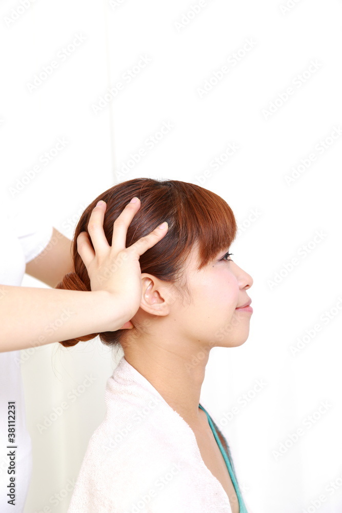 young Japanese woman getting head massage young Japanese woman getting head massage