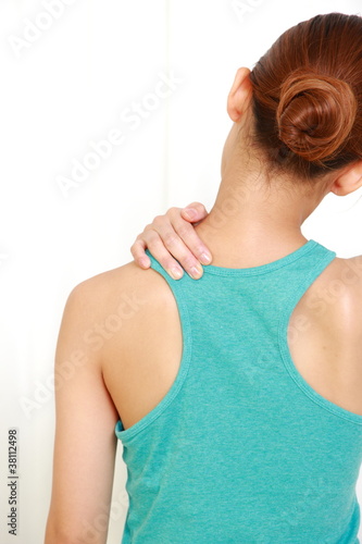 young woman doing self shoulder massage