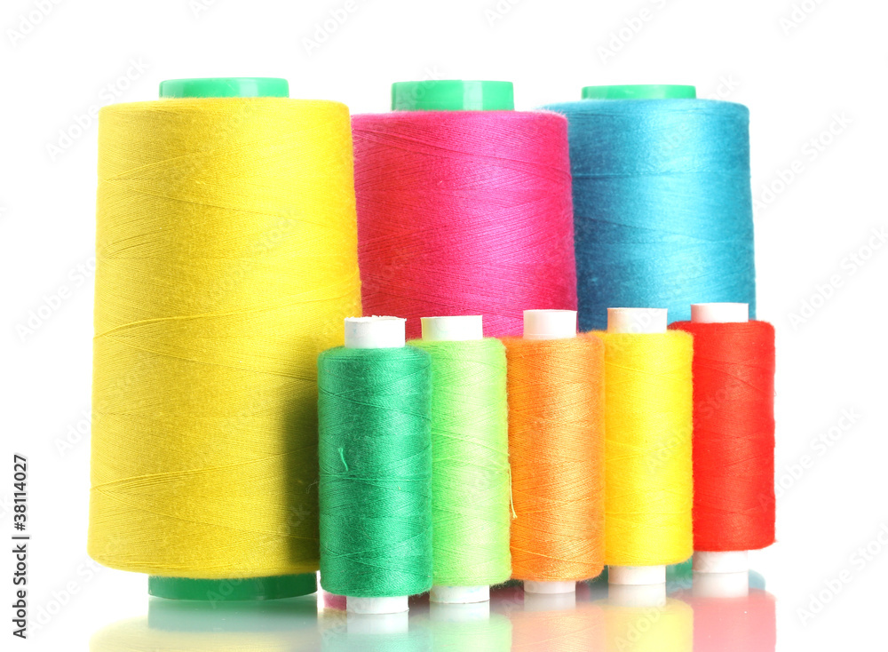 Many-coloured bobbins of thread isolated on white Many-coloured bobbins of thread isolated on white