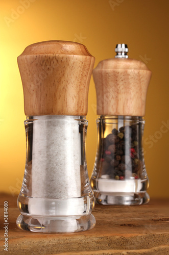 Salt and pepper mills on yellow