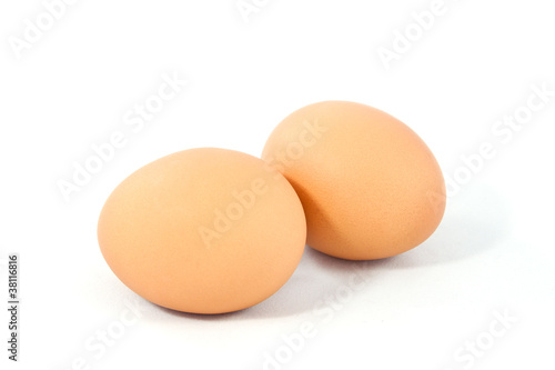 Two brown eggs isolated on white background