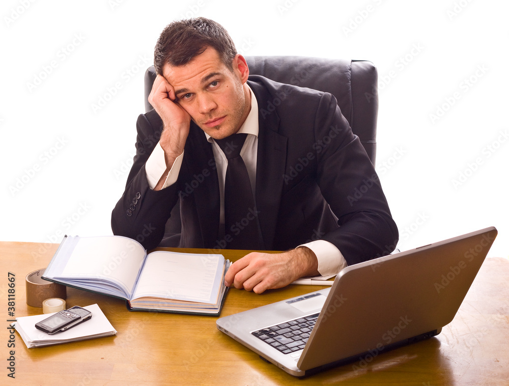 young business man sitting at a desk. young business man sitting at a desk.