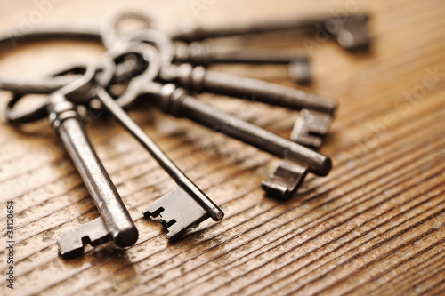 old keys on a wooden table, close-up