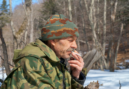 Man smoking in forest 5