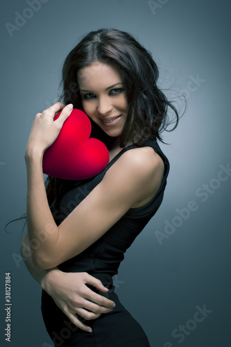 Valentine's Day. Beautiful smiling woman with a gift