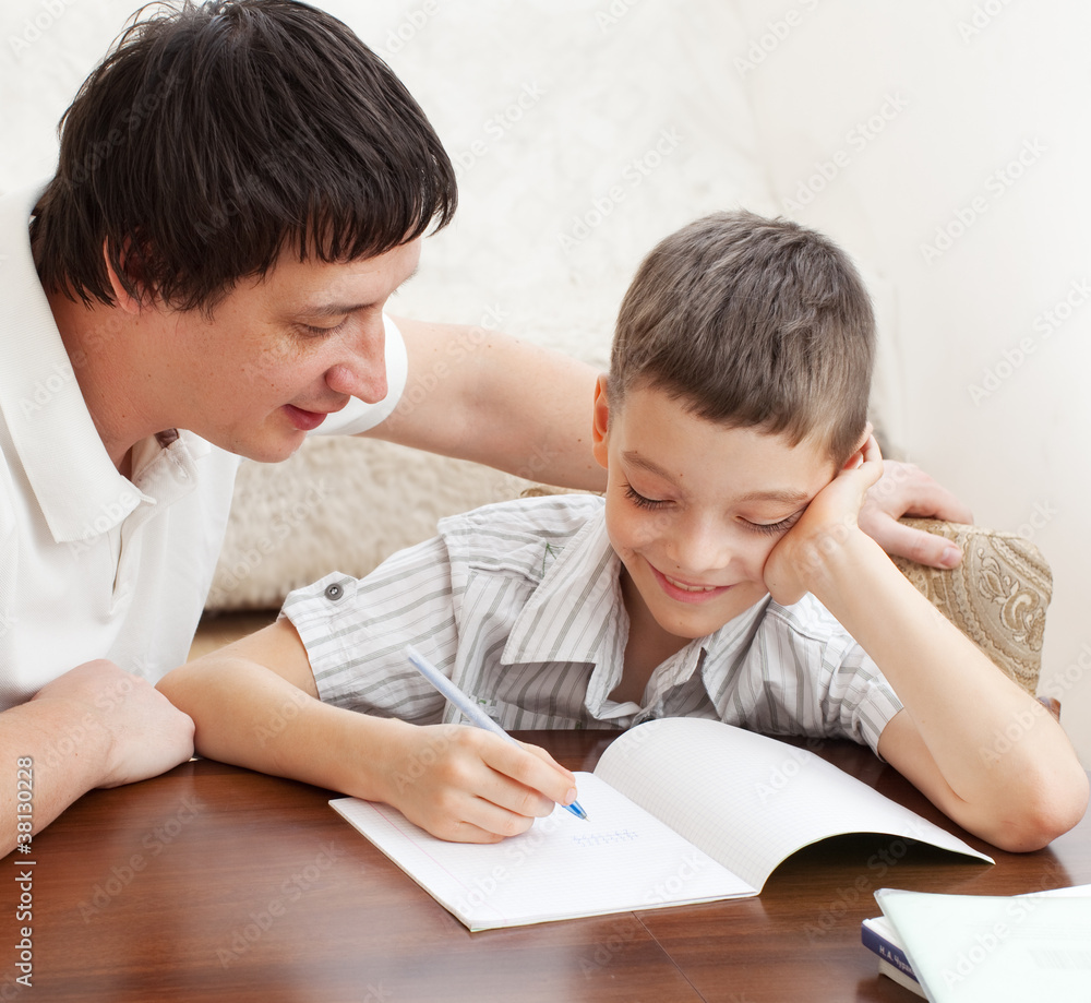 Father helping son do homework Father helping son do homework