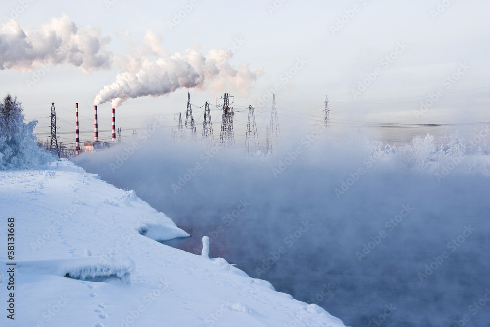 Winter landscape with steam over the river and factory Winter landscape with steam over the river and factory