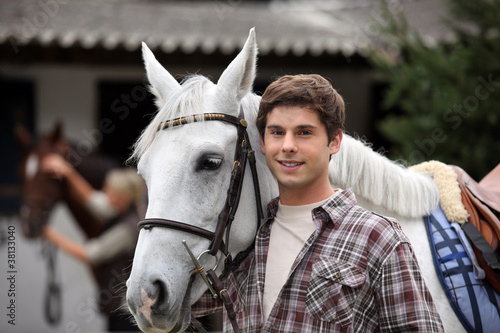 фотографія portrait of a young man with horse