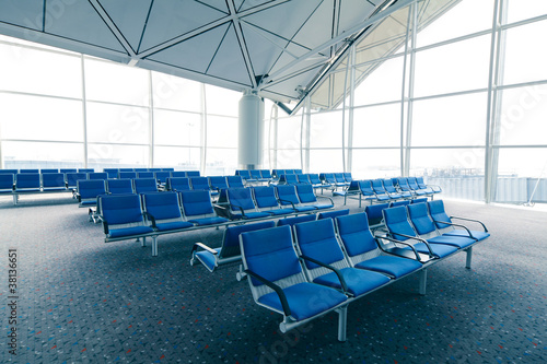 row of blue chair at airport in Hongkong