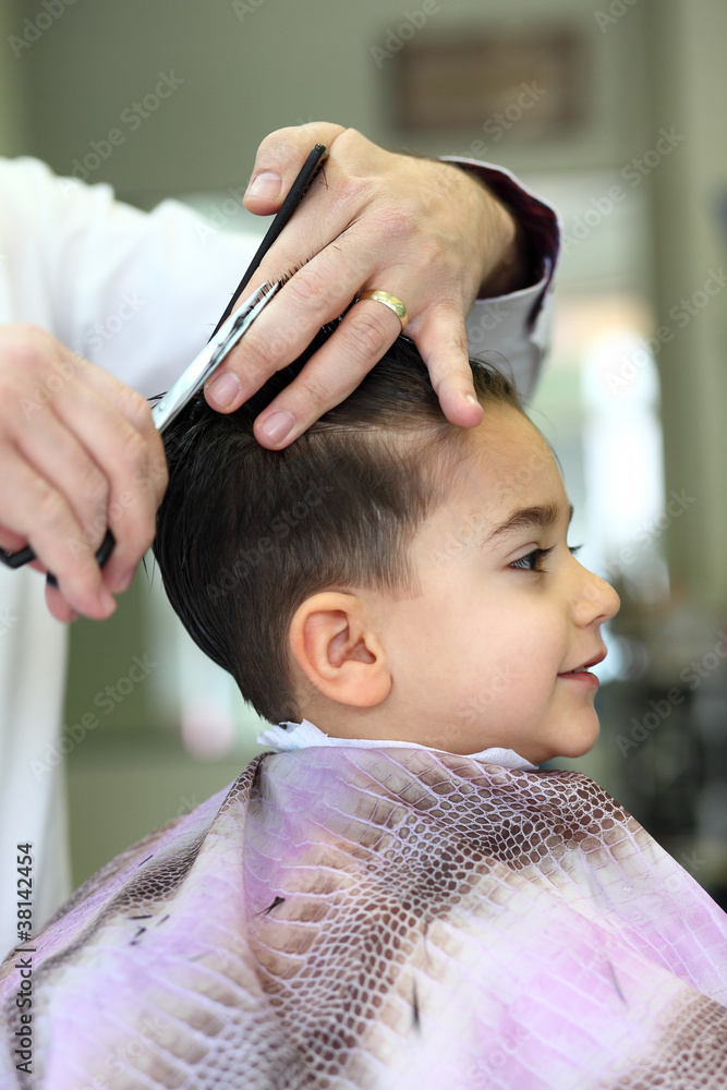 Fototapeta premium Lovely child at hairdresser