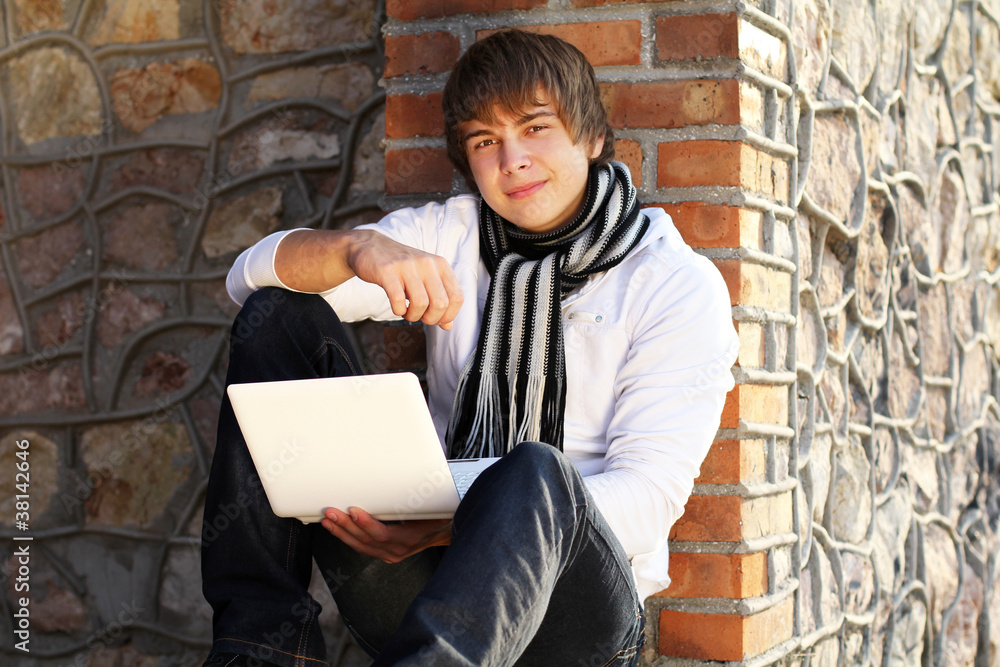 Young man with laptop outdoor Young man with laptop outdoor