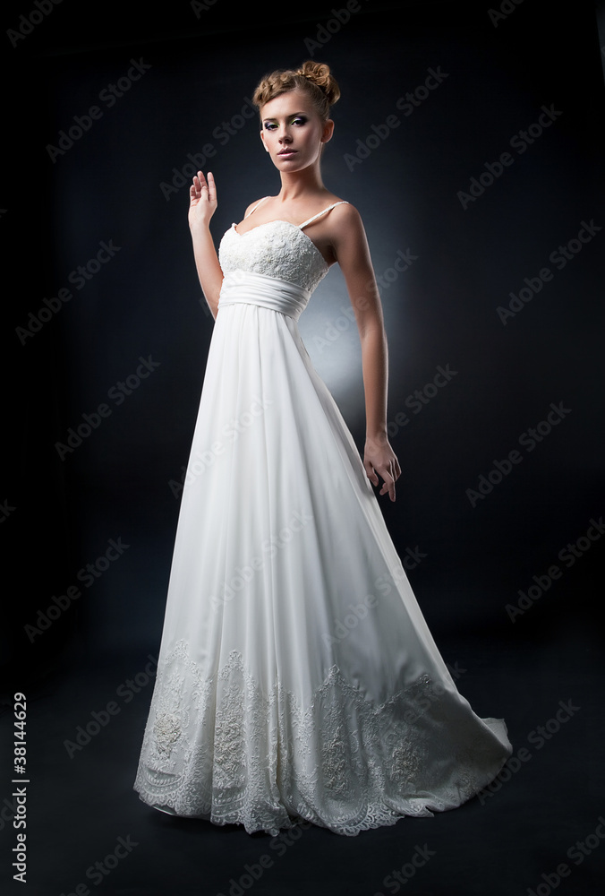Romantic bride fashion model demonstrates white wedding dress Romantic bride fashion model demonstrates white wedding dress