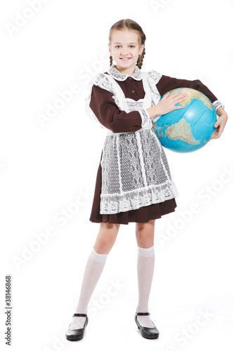 Young beauty girl in school clothing with globe posing