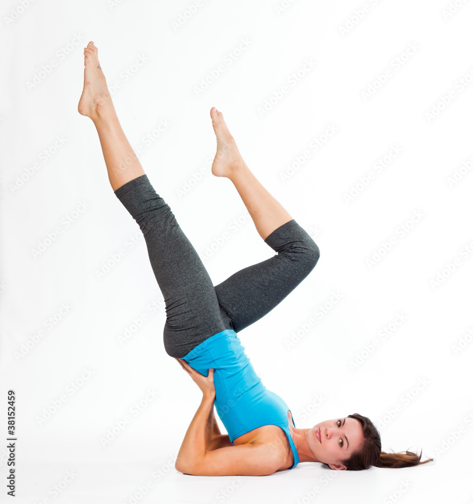 Beautiful young woman holding yoga pose