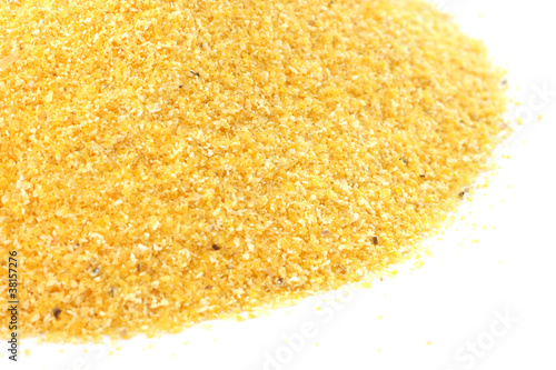 Yellow corn flour scattered on white background