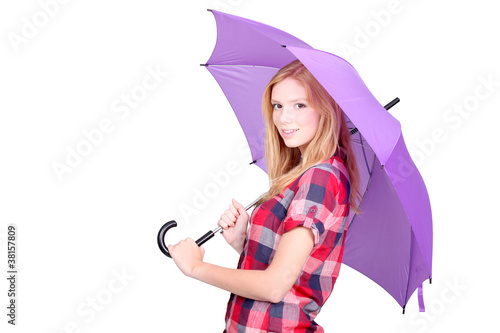 Pretty young woman under a bright purple umbrella