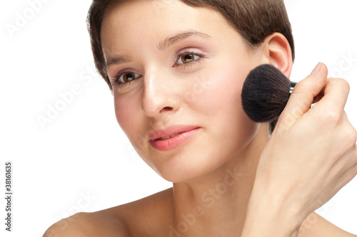 Tablou canvas Young woman applying makeup