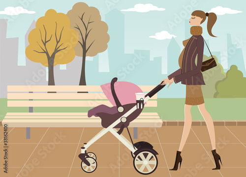 Young mom taking her baby for a stroll through park
