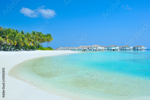 Maldives water villa - bungalows and white beach © totophotos
