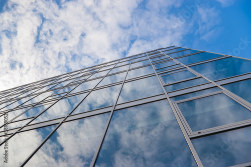 building with clouds reflection