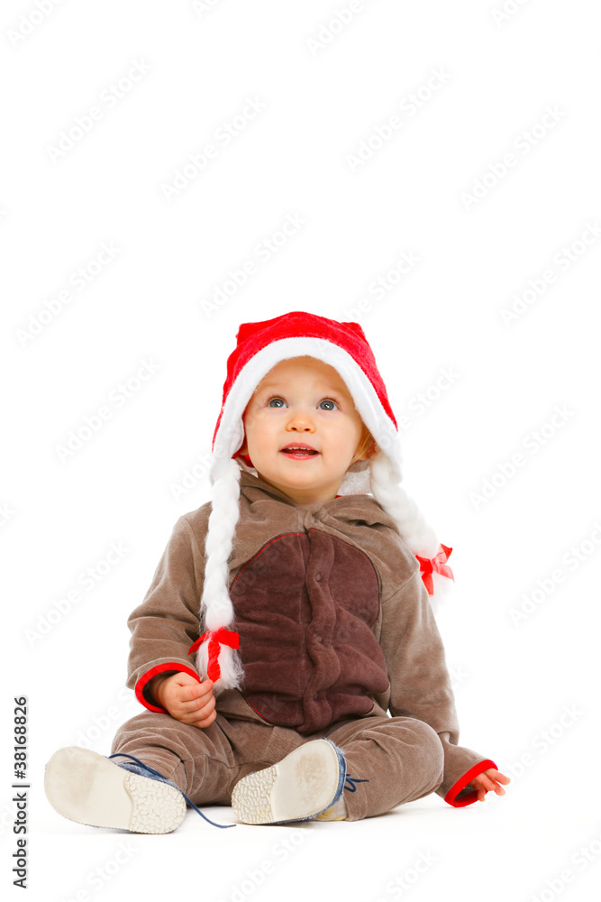 Portrait of cute baby in Santa hat looking up Portrait of cute baby in Santa hat looking up