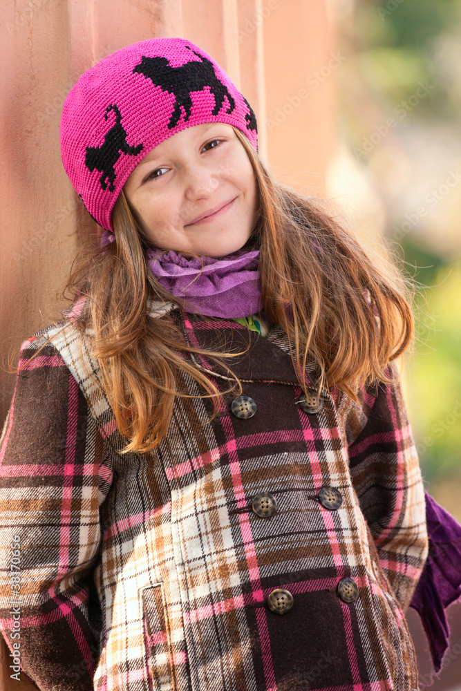 smiling girl standing near the column at the park smiling girl standing near the column at the park