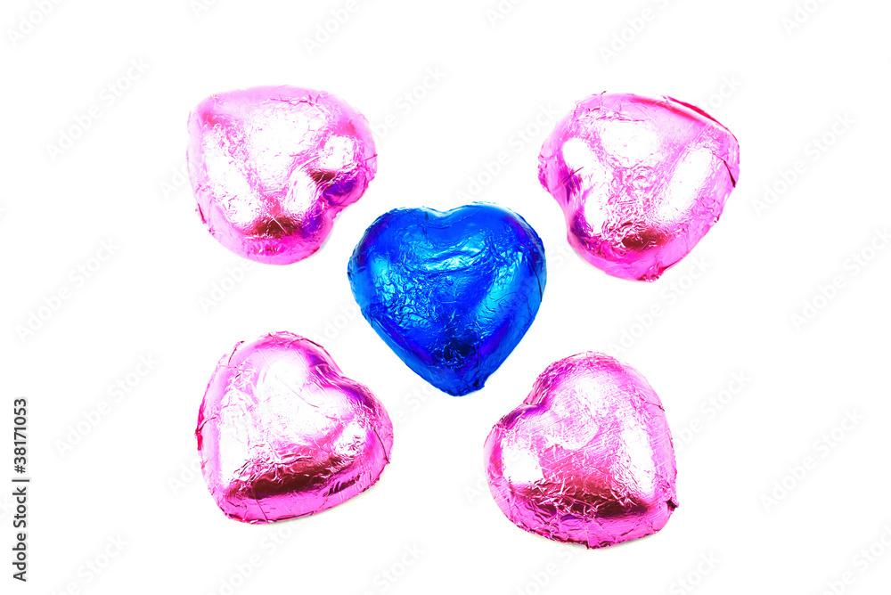 Fototapeta premium Wrapped chocolate hearts on white background