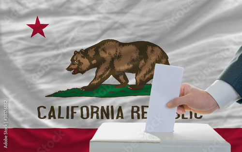 man voting on elections in front of flag US state flag of califo