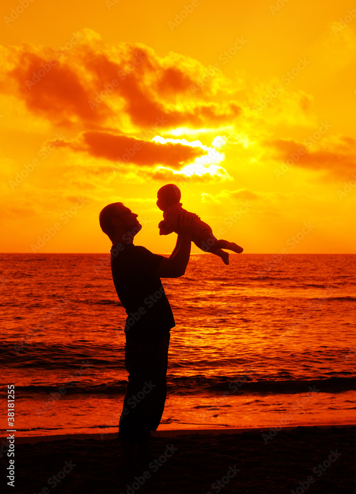 father with little baby on the sea