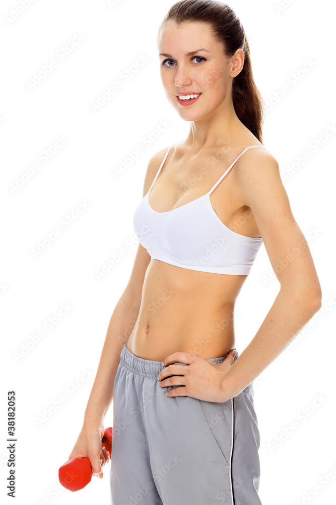 Fototapeta premium Pretty happy young woman exercising with free weights