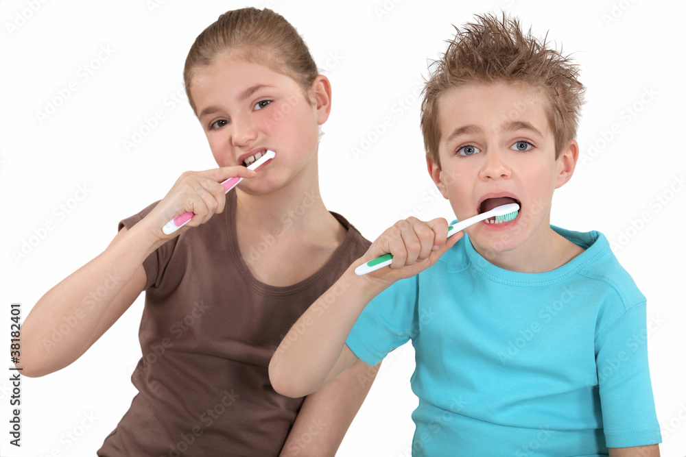 Brother and sister brushing their teeth. Brother and sister brushing their teeth.