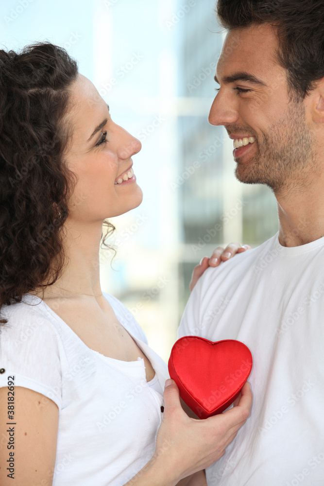 Holding heart-shaped box Holding heart-shaped box