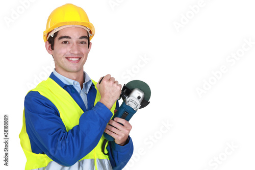 Smiling laborer holding sander
