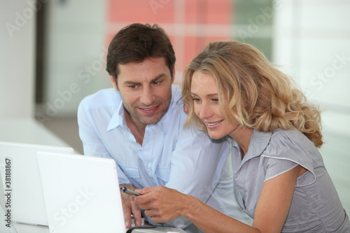 Couple at work on laptops