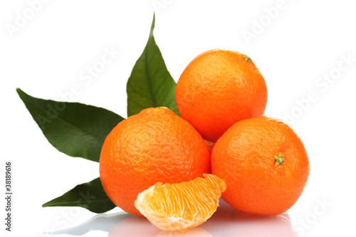 Ripe tasty tangerines with leaves and segments isolated on white