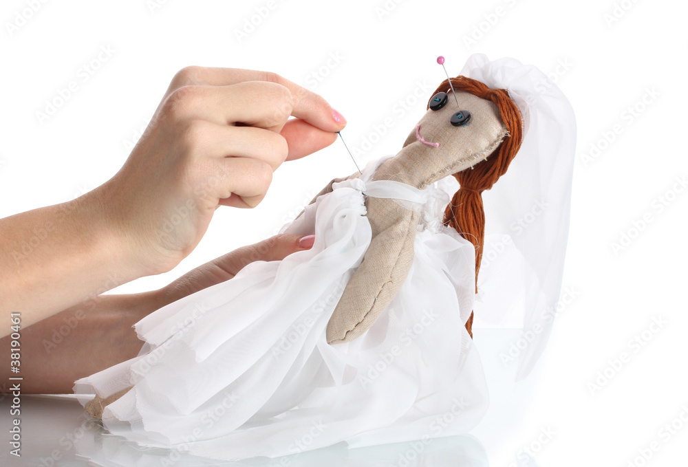 Naklejka premium Voodoo doll girl-bride in the hands of women isolated on white