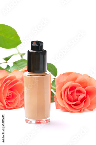 Natural cosmetics concept: foundation cream with roses, on white