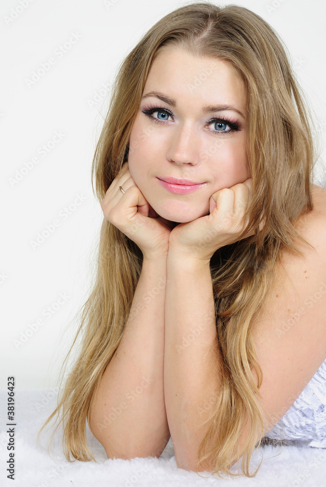 The young beautiful girl an angel with wings on a white backgrou The young beautiful girl an angel with wings on a white backgrou