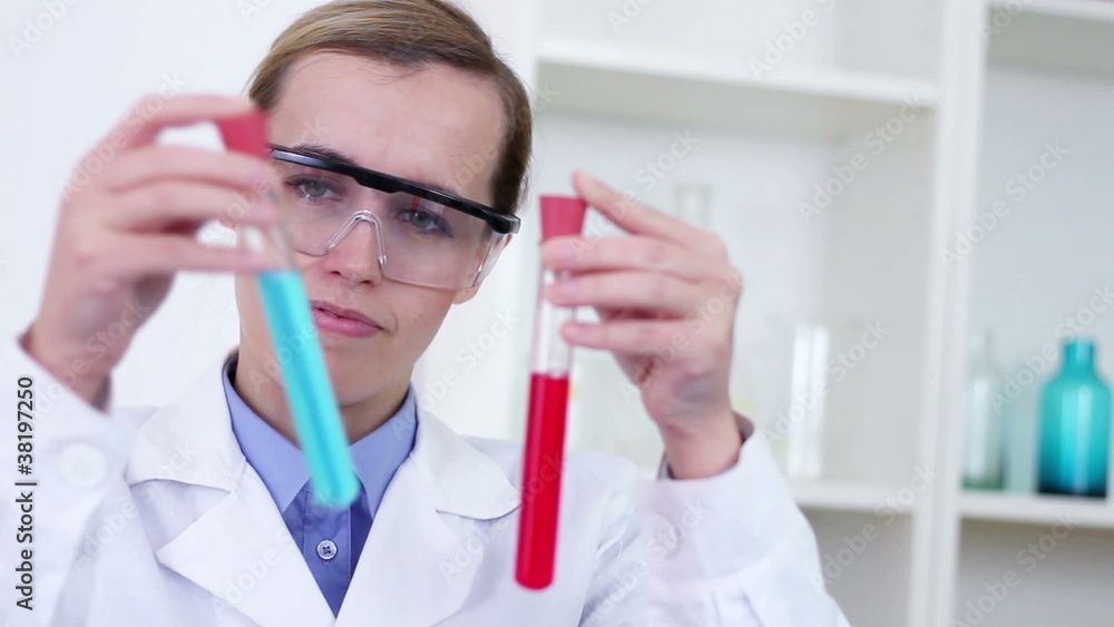 scientist comparing test tubes with red and blue substance scientist comparing test tubes with red and blue substance