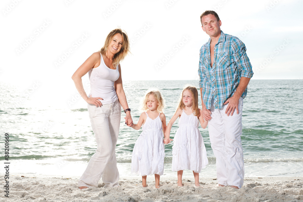 Young family enjoy sunny day at the beach.