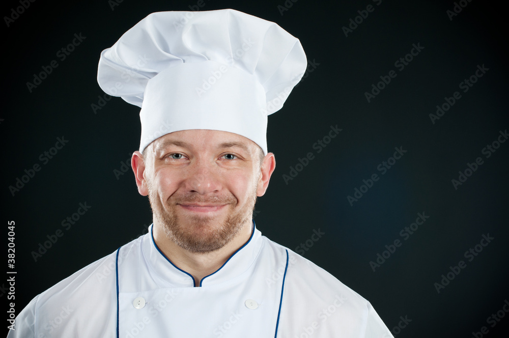 Studio shot of positive chef in uniform smiling Studio shot of positive chef in uniform smiling