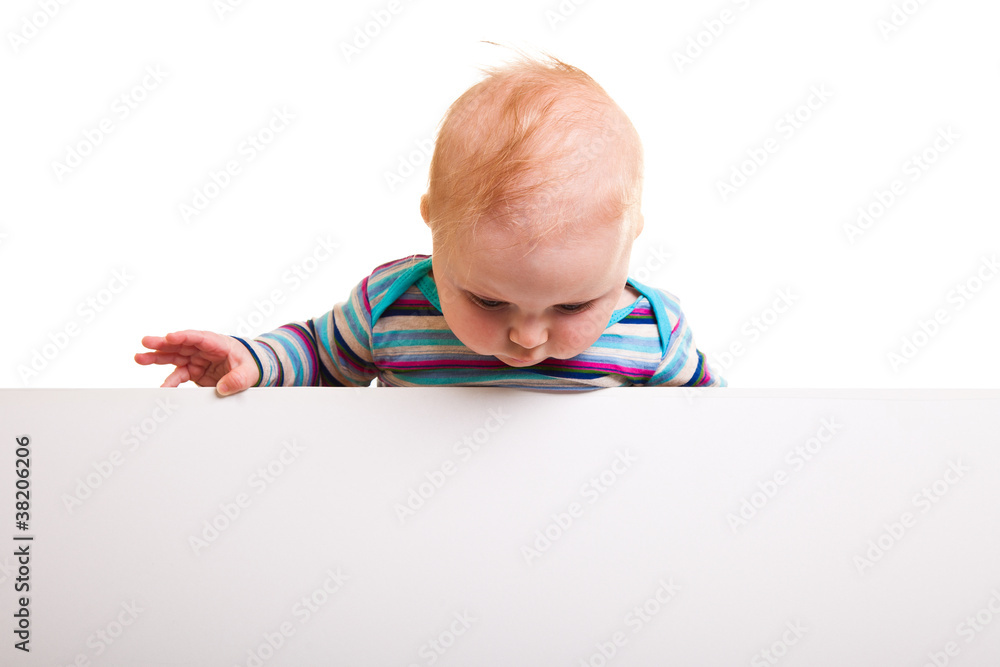 Isolated beaufiful caucasian infant baby behind whiteboard Isolated beaufiful caucasian infant baby behind whiteboard